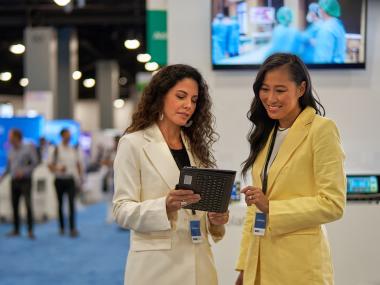 Two ladies in the Miami Beach convention center exhibit hall